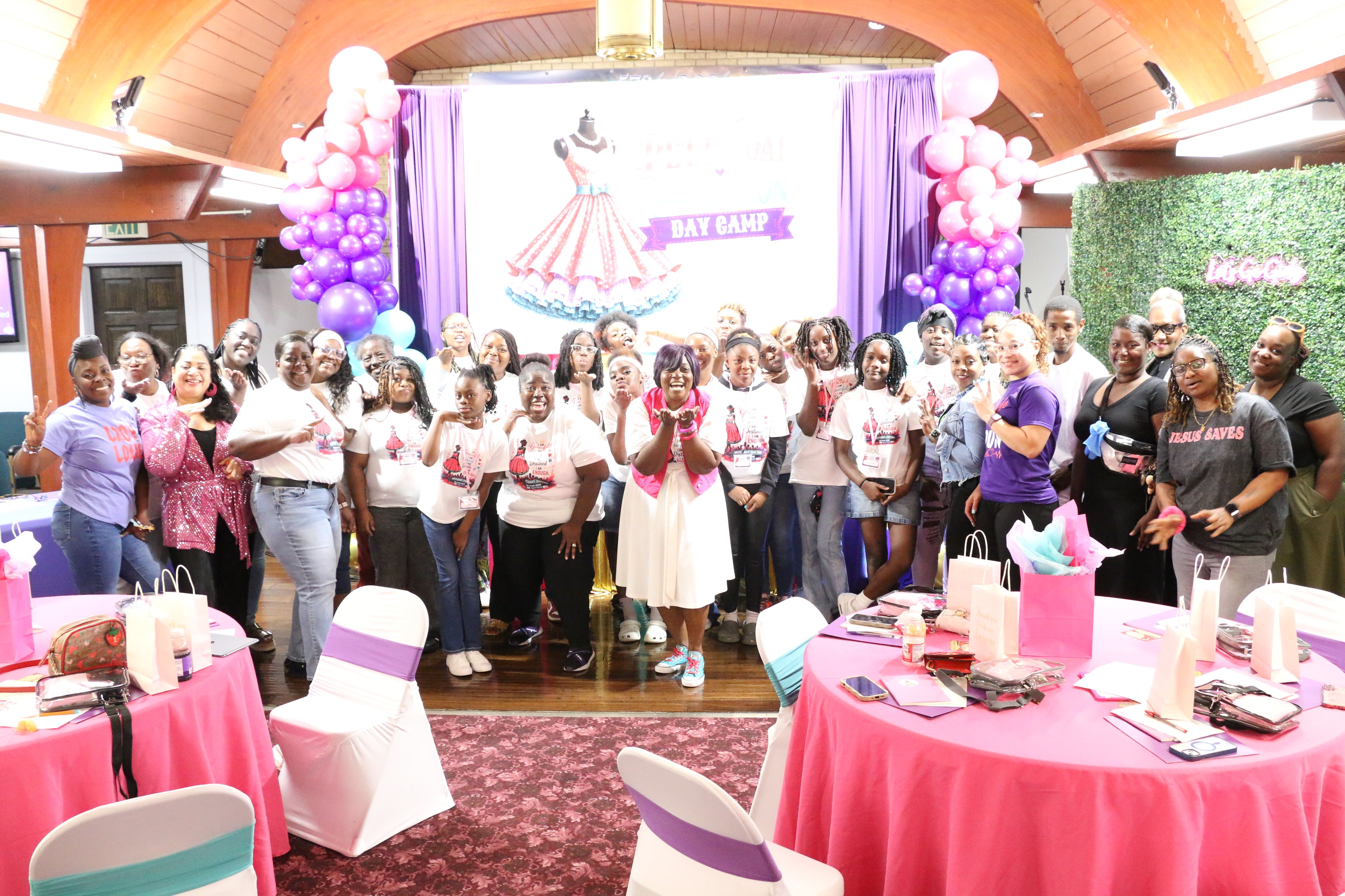 Large group photo of Petticoat Junction Day Camp attendees in front of the decorated stage
