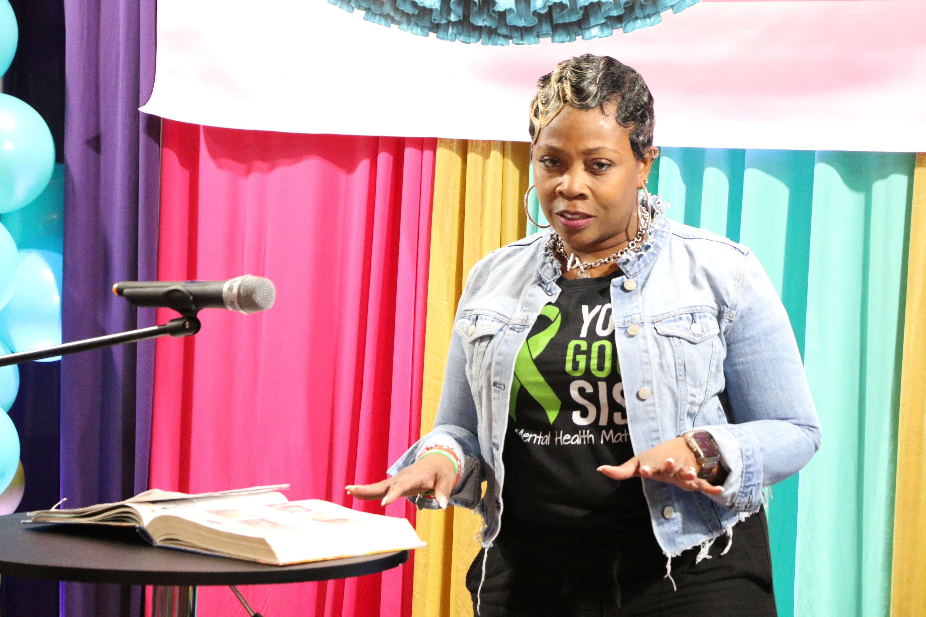 Speaker presenting at the colorful Petticoat Junction stage backdrop
