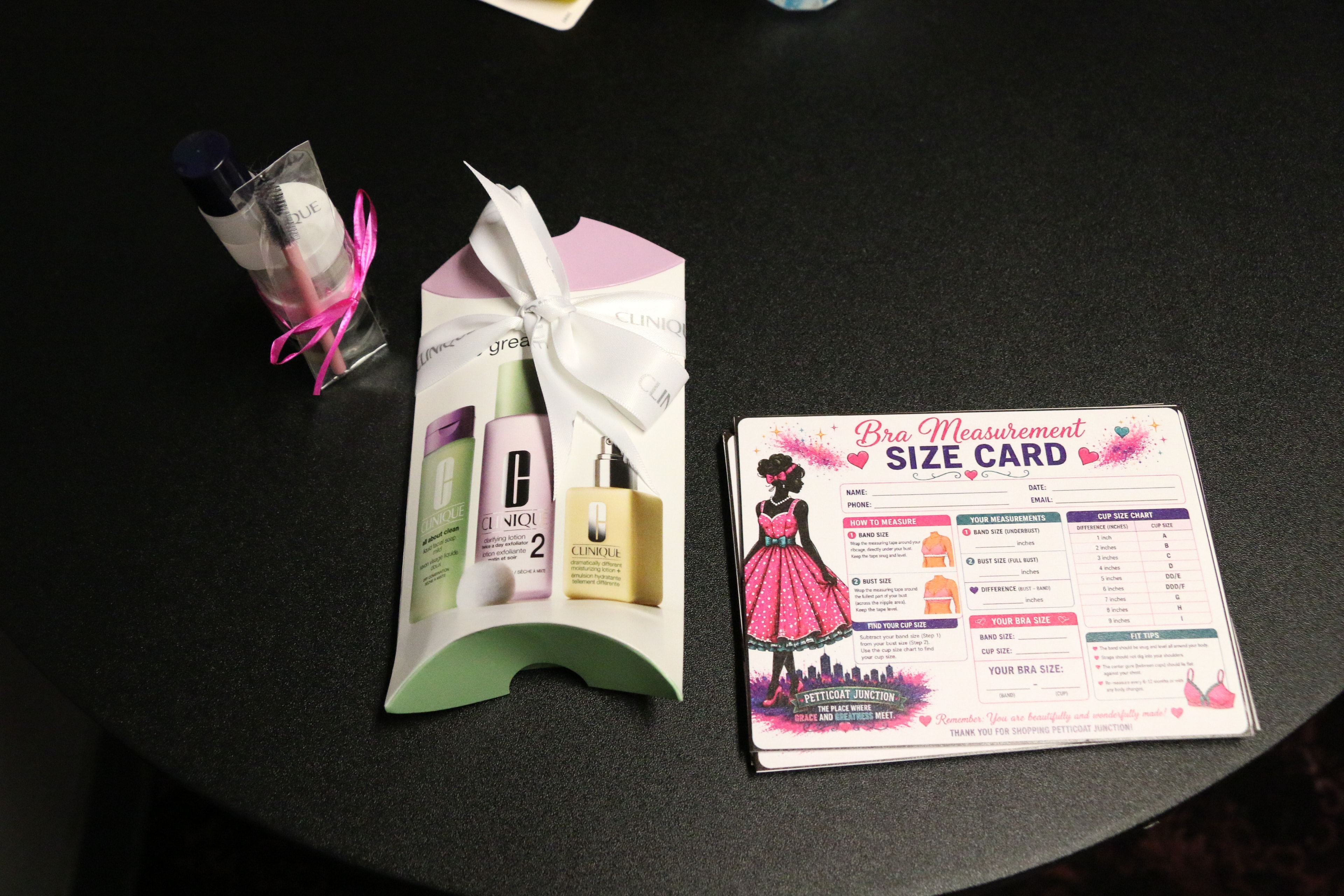 Clinique skincare gift set and bra measurement size card on display